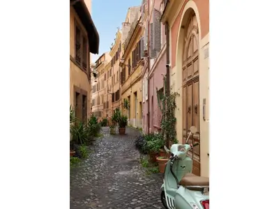 a scooter parked on a street in an alley at Golden Tulip Rome Piram in Rome
