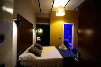 a bedroom with a bed in a room with a light at Hotel Felice in Rome