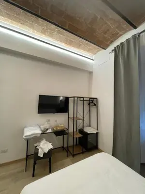 a bedroom with a bed with a large window at Hotel Felice in Rome