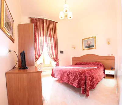 a bedroom with a bed and a television in it at Hotel Euro Quiris in Rome