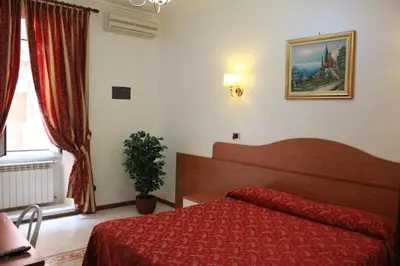 a bedroom with a red bed and a window at Hotel Euro Quiris in Rome