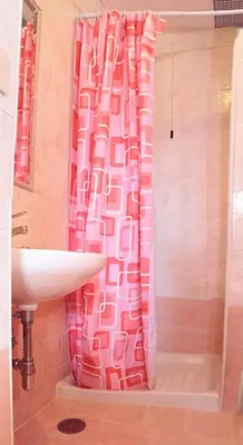 a bathroom with a pink shower curtain and a sink at Hotel Euro Quiris in Rome