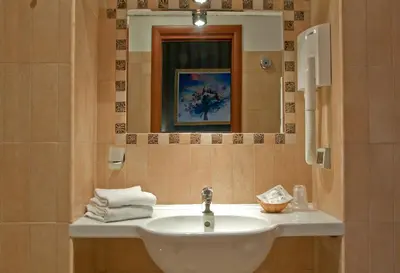 a bathroom with a sink and a mirror at Hotel Lirico in Rome
