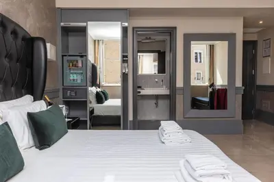 a bedroom with a bed with two towels on it at Hotel Castellino Roma in Rome
