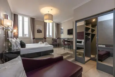 a hotel room with a bed and a living room at Hotel Castellino Roma in Rome