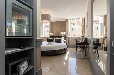 a hotel room with a bed and a television at Hotel Castellino Roma in Rome