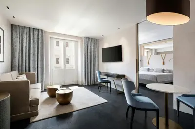 a hotel room with a living area and a bedroom at Sina Bernini Bristol, Autograph Collection in Rome