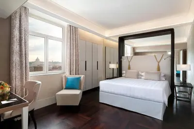 a bedroom with a bed and a desk and a chair at Sina Bernini Bristol, Autograph Collection in Rome