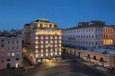 a lit up building in a city at night at Sina Bernini Bristol, Autograph Collection in Rome