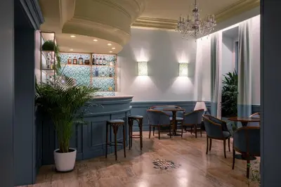 a restaurant with a bar with chairs and tables at Hotel Montecarlo in Rome