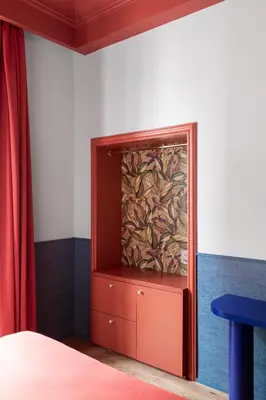 a red cabinet in a room with a painting on the wall at Hotel Montecarlo in Rome