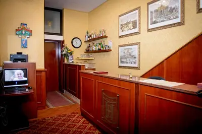 a bar in a restaurant with a tv in a room at Hotel Emmaus in Rome