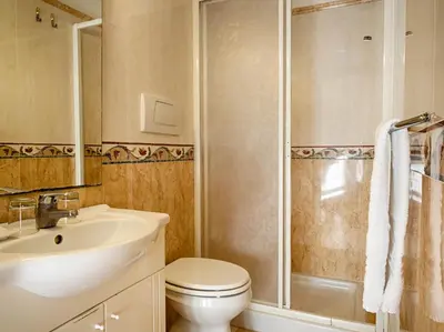 a bathroom with a toilet and a sink and a shower at Sunny Guest House in Rome