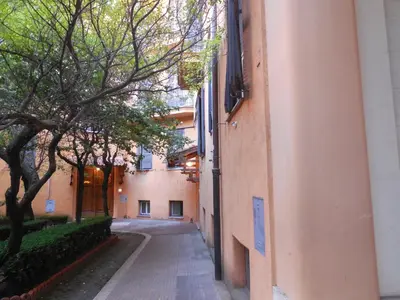 an alley between two buildings with trees on the side at Sunny Guest House in Rome