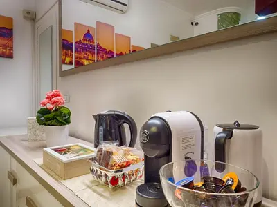 a kitchen counter with a coffee maker on a counter at Sunny Guest House in Rome