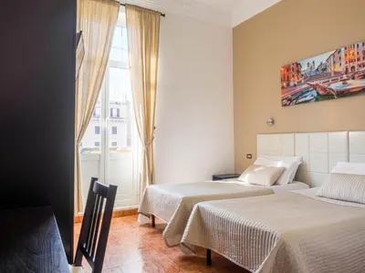 a hotel room with two beds and a window at Sunny Guest House in Rome