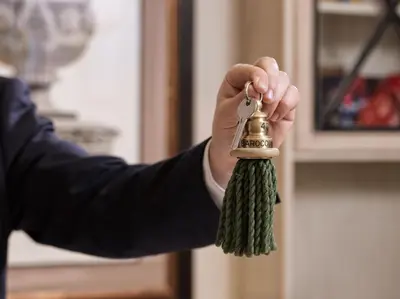 a man holding a bunch of tassels in his hand at Hotel Barocco in Rome