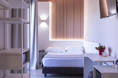 a small bedroom with a bed and a window at Garner Hotel Rome Aurelia by IHG in Rome