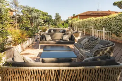 a row of chairs and tables on a patio at Garner Hotel Rome Aurelia by IHG in Rome