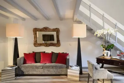 a living room with a couch with red pillows at Colonna Palace Hotel in Rome