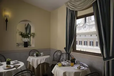 a dining room with two tables and a window at Colonna Palace Hotel in Rome