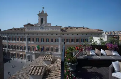 a large building with a clock tower on top of it at Colonna Palace Hotel in Rome
