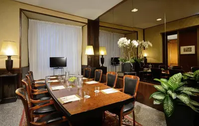 a conference room with a long table and chairs at Colonna Palace Hotel in Rome
