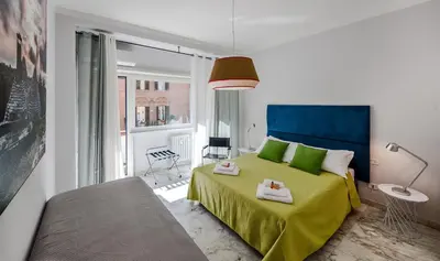 a bedroom with a green bed and a window at Magenta Vaticano Fornaci in Rome