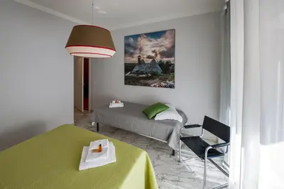 a bedroom with a bed and a table and a chair at Magenta Vaticano Fornaci in Rome