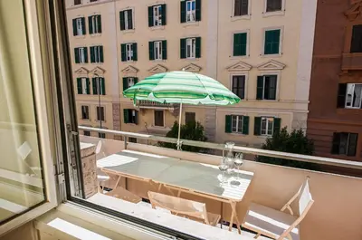 a balcony with a table and an umbrella at Magenta Vaticano Fornaci in Rome
