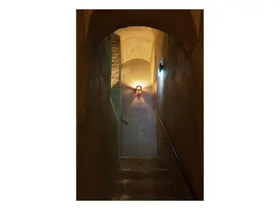a stairway with a light at the end of a tunnel at Casa de' Coronari in Rome