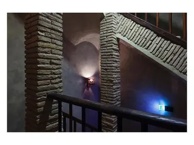 a room with a stone wall with a light on it at Casa de' Coronari in Rome
