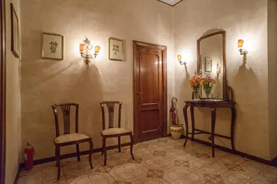 a hallway with two chairs and a mirror at Amici di Roma in Rome
