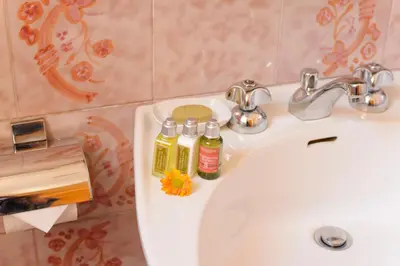 a bathroom sink with two bottles of soap on it at Amici di Roma in Rome