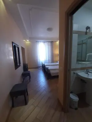 a room with a bed and a bathroom with a sink at B&B Rome With Love in Rome