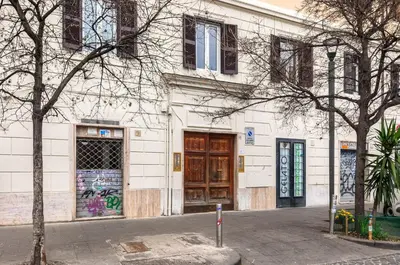 a building with graffiti on the side of it at S. Cosimato Trastevere in Rome