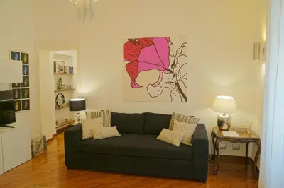 a living room with a couch and a painting on the wall at S. Cosimato Trastevere in Rome