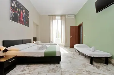 a bedroom with two beds and a bench in it at Lucky Stars rooms in Rome