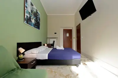 a bedroom with a bed and a tv and a couch at Lucky Stars rooms in Rome