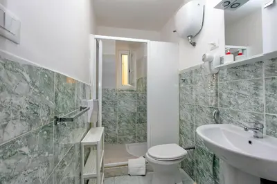a bathroom with a toilet and a sink and a shower at Lucky Stars rooms in Rome