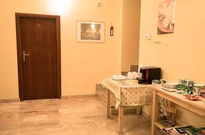 a room with a table and a wooden door at Parioli House in Rome