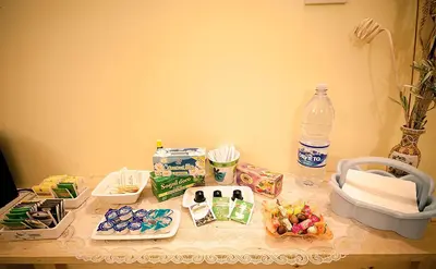 a table topped with food and a bottle of water at Parioli House in Rome