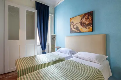 a bedroom with a bed and a painting on the wall at House Montebello in Rome