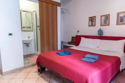 a bedroom with a bed with two blue towels on it at fruitroom rome in Rome