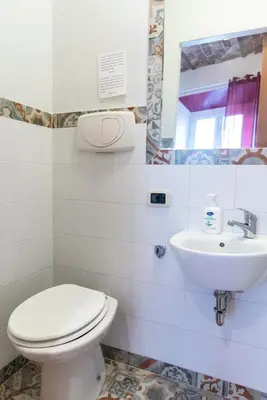 a bathroom with a toilet and a sink at fruitroom rome in Rome