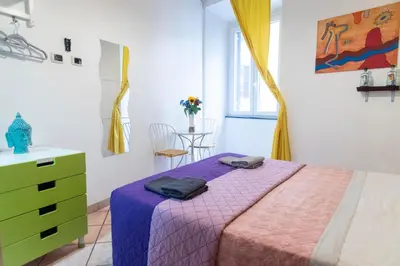 a bedroom with a bed and a dresser and a window at fruitroom rome in Rome