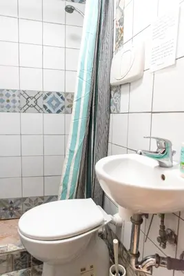 a bathroom with a toilet and a sink at fruitroom rome in Rome