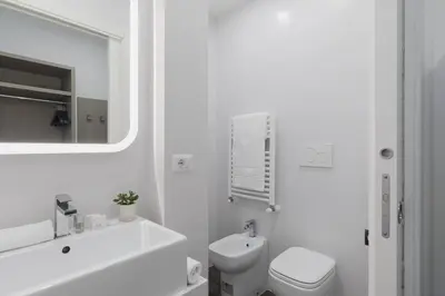 a white bathroom with a sink and a toilet at Residenza Il Duca in Rome