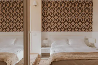 a bedroom with two beds and a wall mural at Residenza Il Duca in Rome