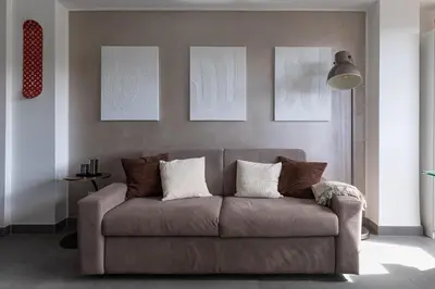 a living room with a couch and some pictures on the wall at Radio Hotel in Rome